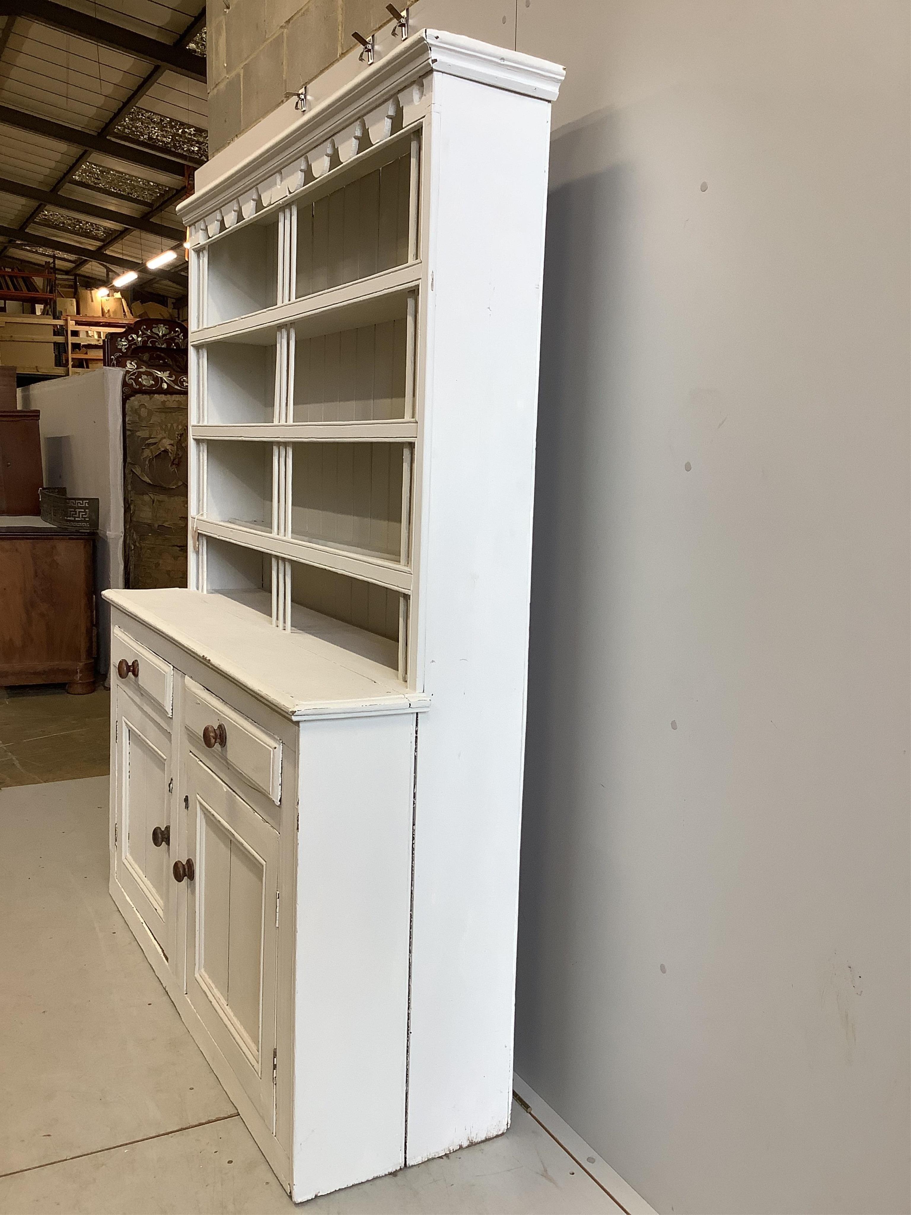 A 19th century Irish pine dresser with boarded rack, later painted, width 162cm, depth 49cm, height 201cm